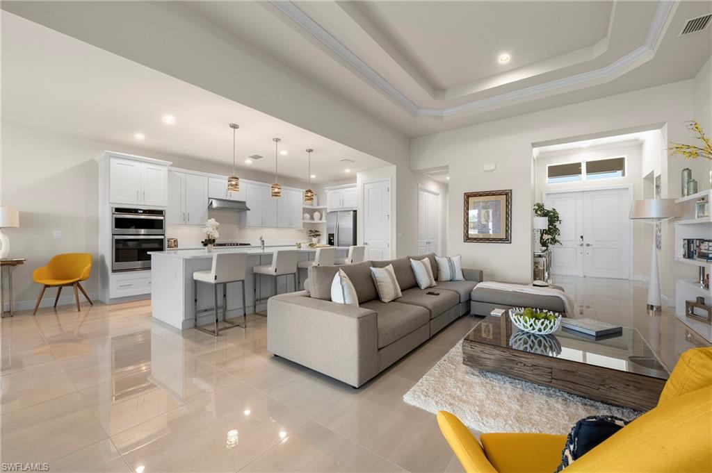 8897 Redonda Drive Naples, FL 34114 - Photo 7 of 42 a living room with furniture and kitchen view