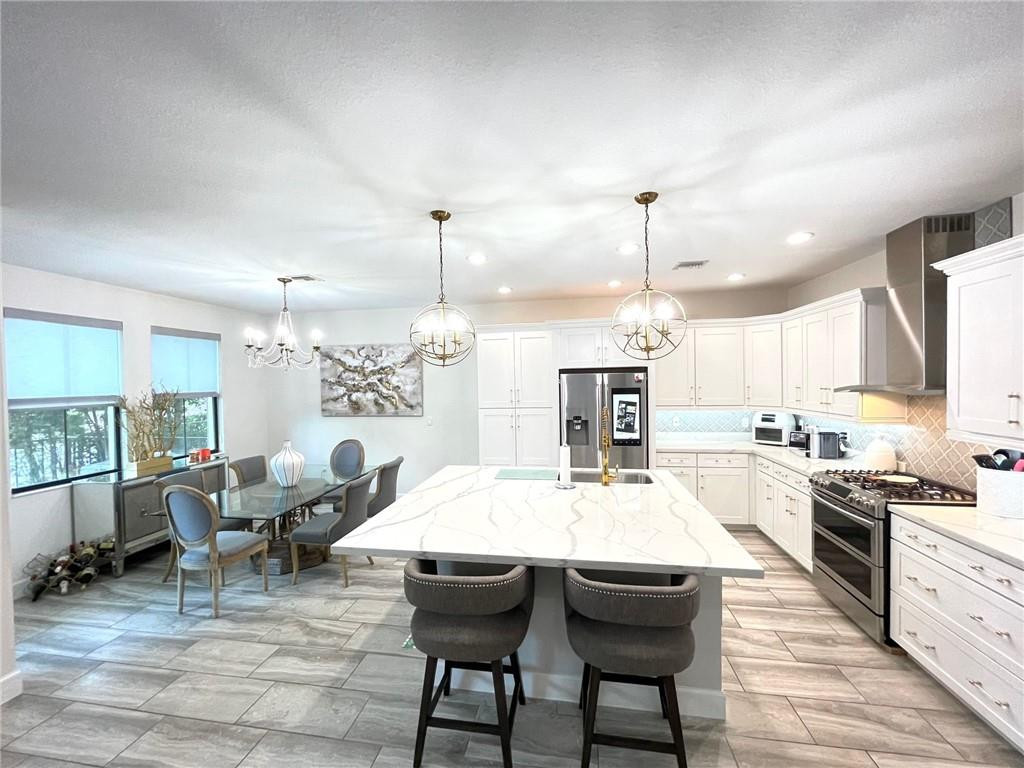 Undisclosed Address Sunrise, FL 33323 - Photo 13 of 88 a large kitchen with a table and chairs