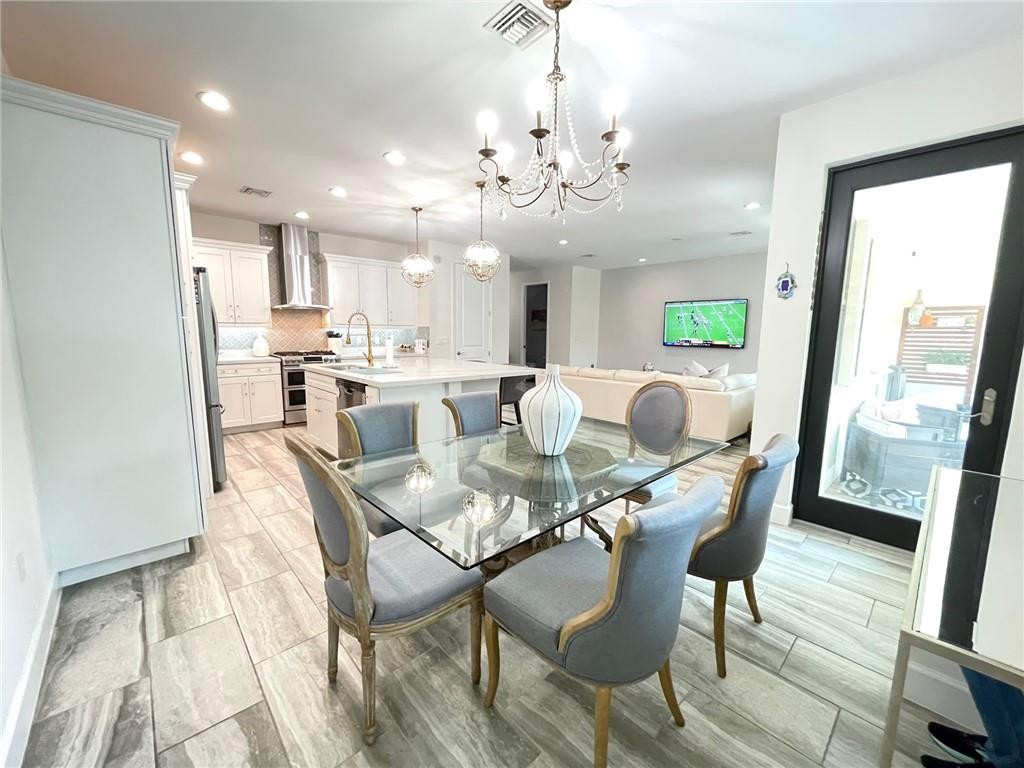 Undisclosed Address Sunrise, FL 33323 - Photo 21 of 88 a view of a dining room with furniture a chandelier and wooden floor