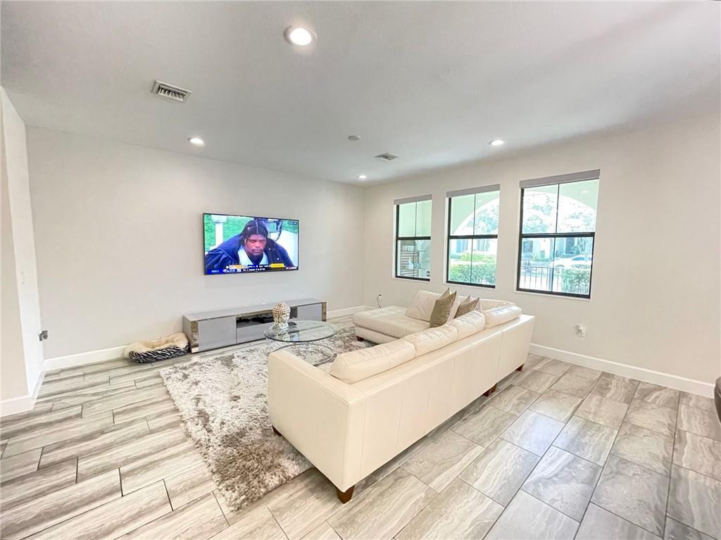 Undisclosed Address Sunrise, FL 33323 - Photo 23 of 88 a living room with furniture and a flat screen tv