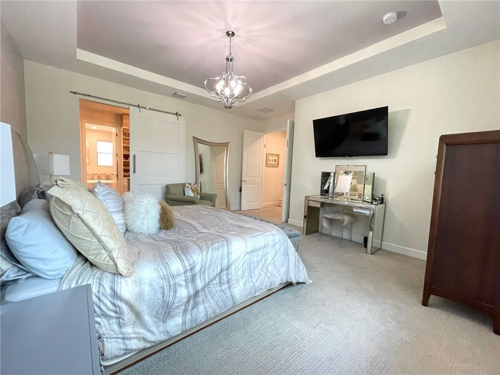 Undisclosed Address Sunrise, FL 33323 - Photo 31 of 88 a spacious bedroom with a bed and a flat screen tv