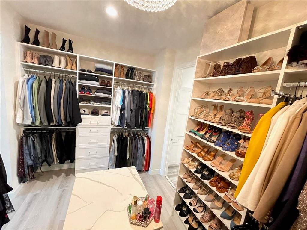 Undisclosed Address Sunrise, FL 33323 - Photo 41 of 88 a view of walk in closet with clothes and shoes