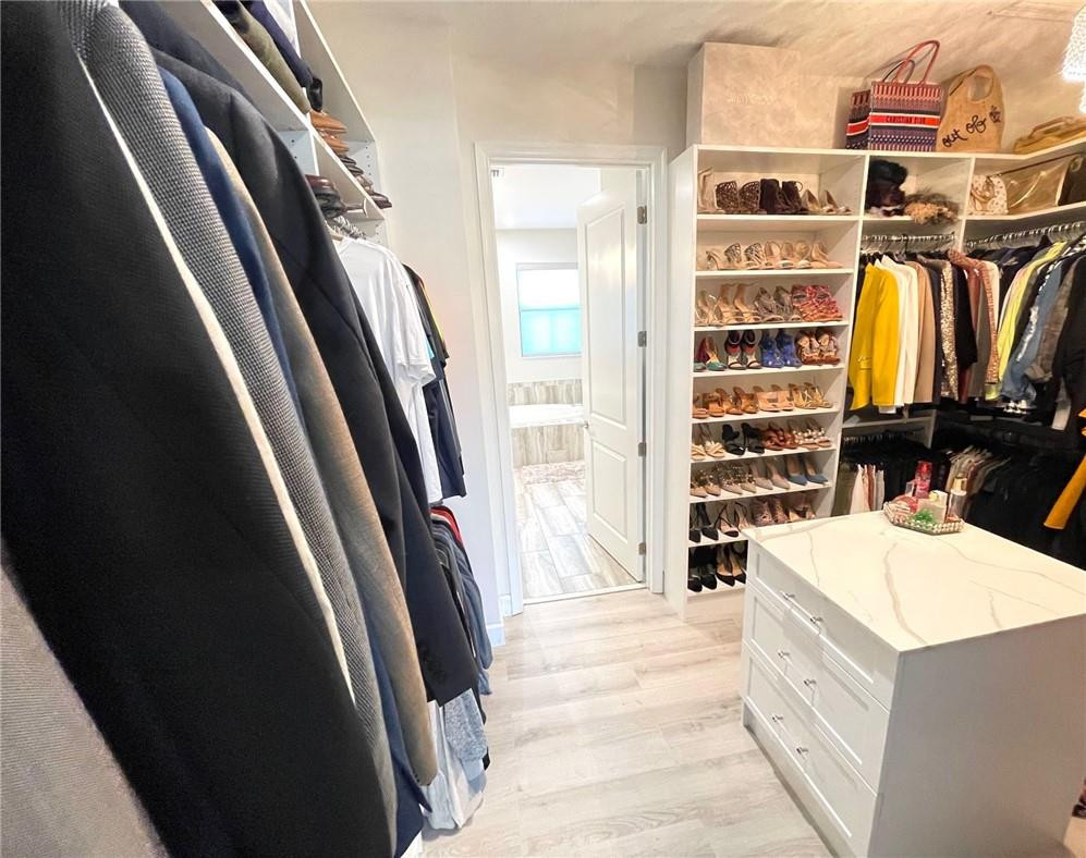 Undisclosed Address Sunrise, FL 33323 - Photo 43 of 88 a view of walk in closet with clothes and shoes