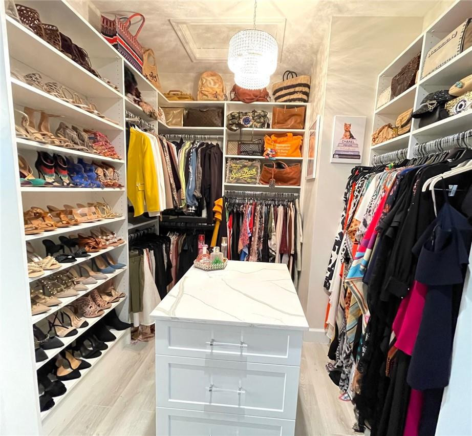 Undisclosed Address Sunrise, FL 33323 - Photo 44 of 88 a view of walk in closet with clothes and shoes