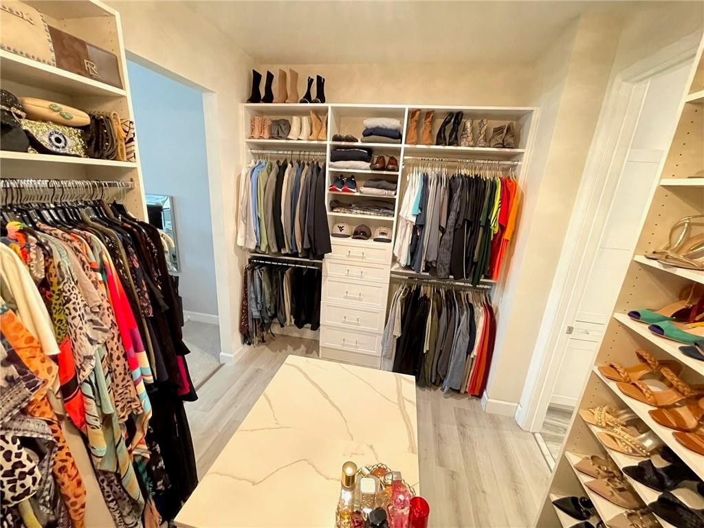 Undisclosed Address Sunrise, FL 33323 - Photo 45 of 88 a view of walk in closet with clothes and shoes