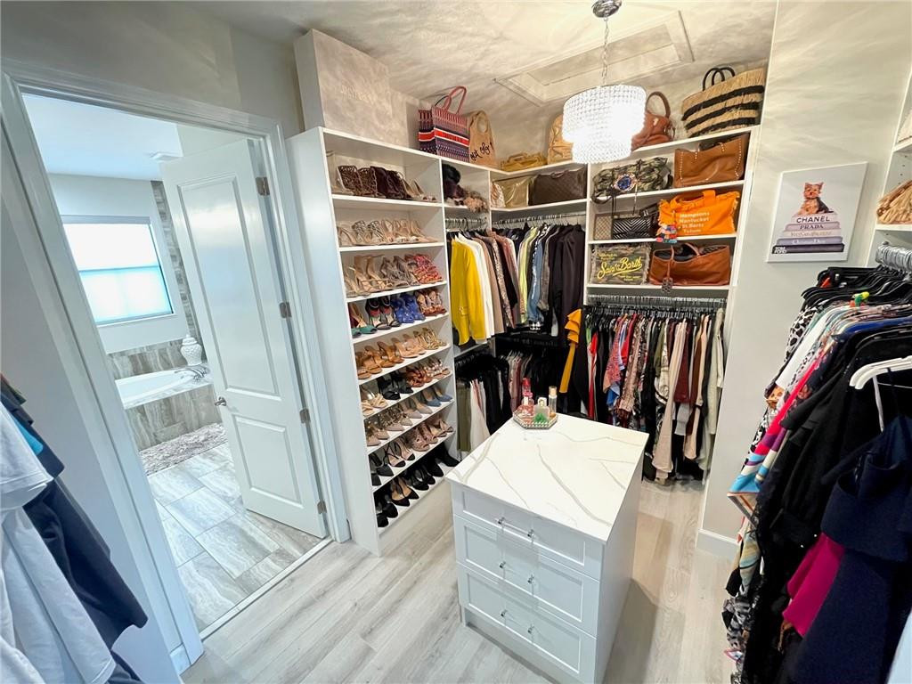 Undisclosed Address Sunrise, FL 33323 - Photo 46 of 88 a view of walk in closet with clothes and shoes