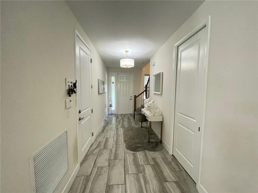 Undisclosed Address Sunrise, FL 33323 - Photo 5 of 88 a view of a hallway with wooden floor and staircase