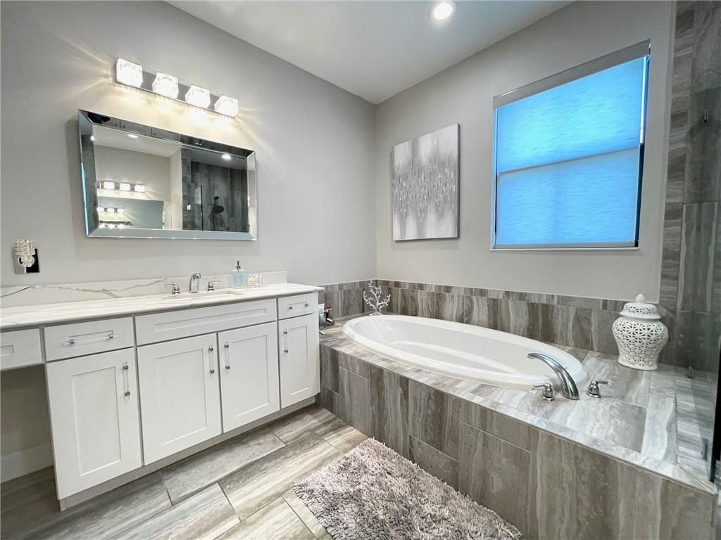 Undisclosed Address Sunrise, FL 33323 - Photo 53 of 88 a bathroom with a double vanity sink mirror and bathtub