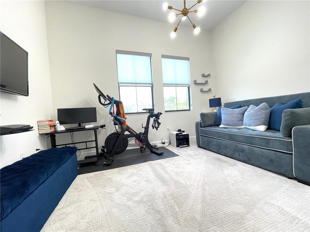 Undisclosed Address Sunrise, FL 33323 - Photo 60 of 88 a living room with furniture a flat screen tv and a window