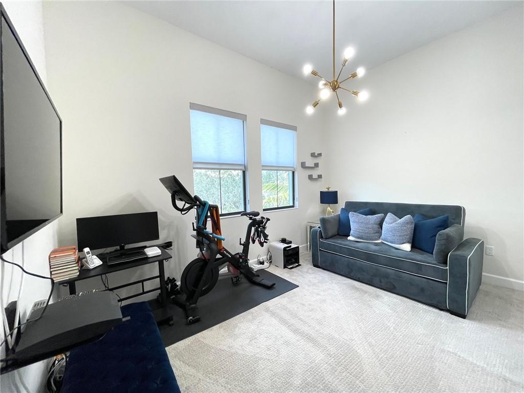 Undisclosed Address Sunrise, FL 33323 - Photo 62 of 88 a living room with furniture a desk and chair with wooden floor