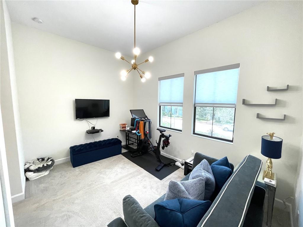 Undisclosed Address Sunrise, FL 33323 - Photo 63 of 88 a living room with furniture a flat screen tv and a window