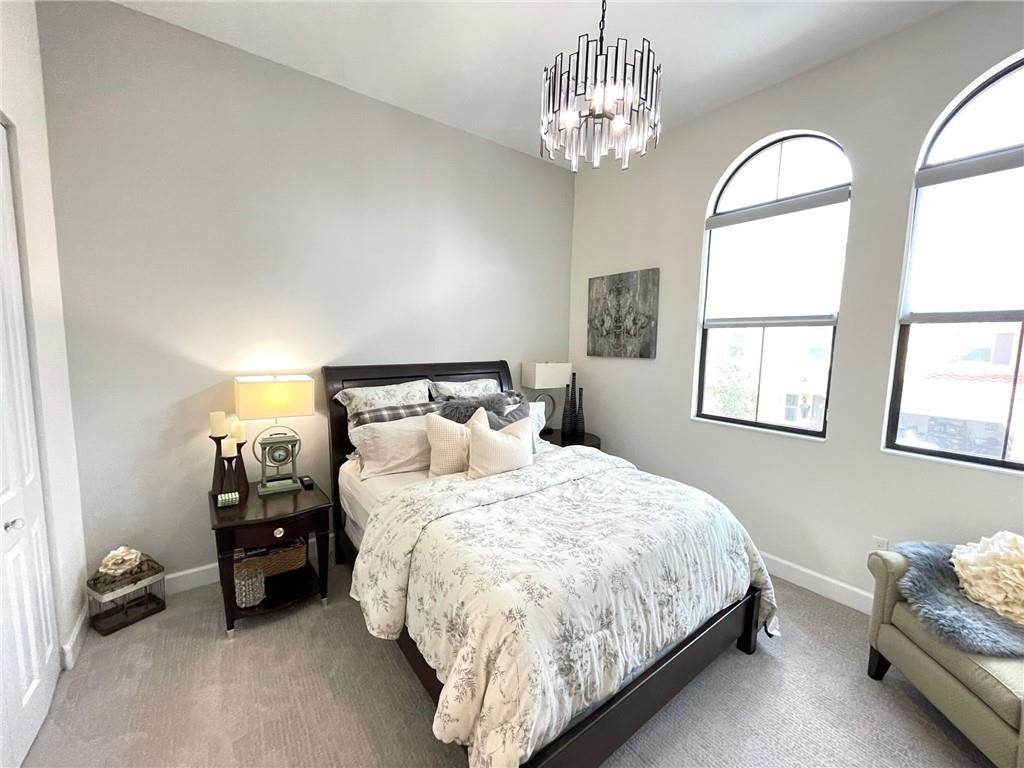 Undisclosed Address Sunrise, FL 33323 - Photo 69 of 88 a bedroom with a bed and a chandelier