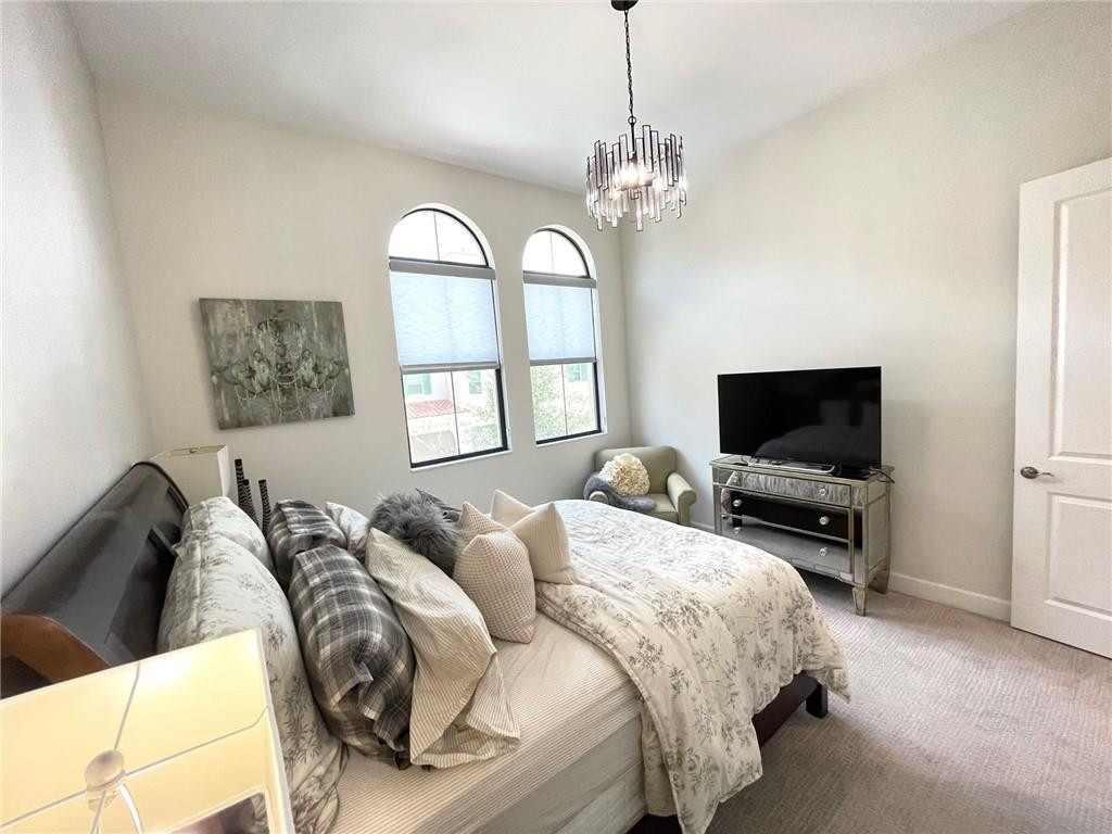 Undisclosed Address Sunrise, FL 33323 - Photo 70 of 88 a spacious bedroom with a bed and a flat screen tv