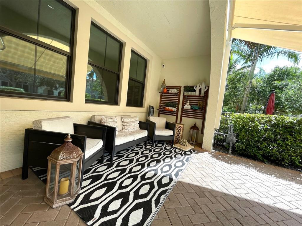 Undisclosed Address Sunrise, FL 33323 - Photo 81 of 88 a view of a patio with table and chairs potted plants with wooden floor