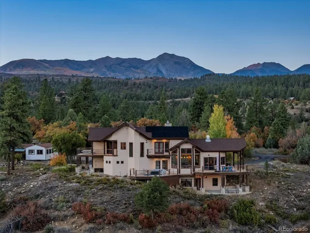 a view of a hallway with wooden floor and a living room