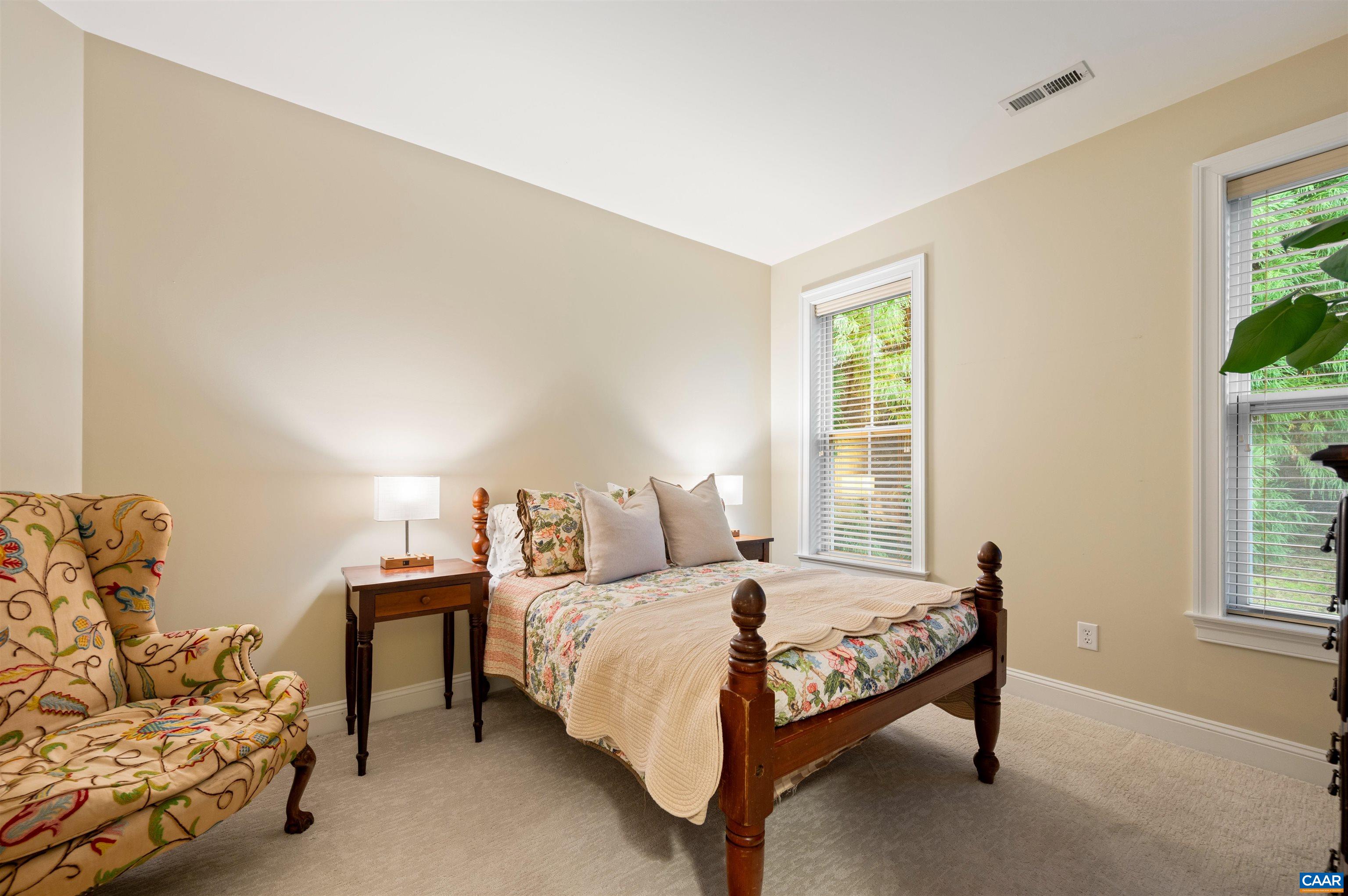 4618 Mechums River Road Charlottesville, VA 22901 - Photo 14 of 44 a bedroom with a bed and a couch next to a window