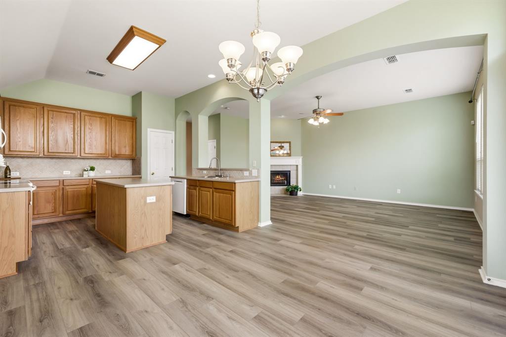 2210 High Point Drive Sachse, TX 75048 - Photo 11 of 23 a view of a kitchen with a sink and dishwasher a refrigerator with wooden floor