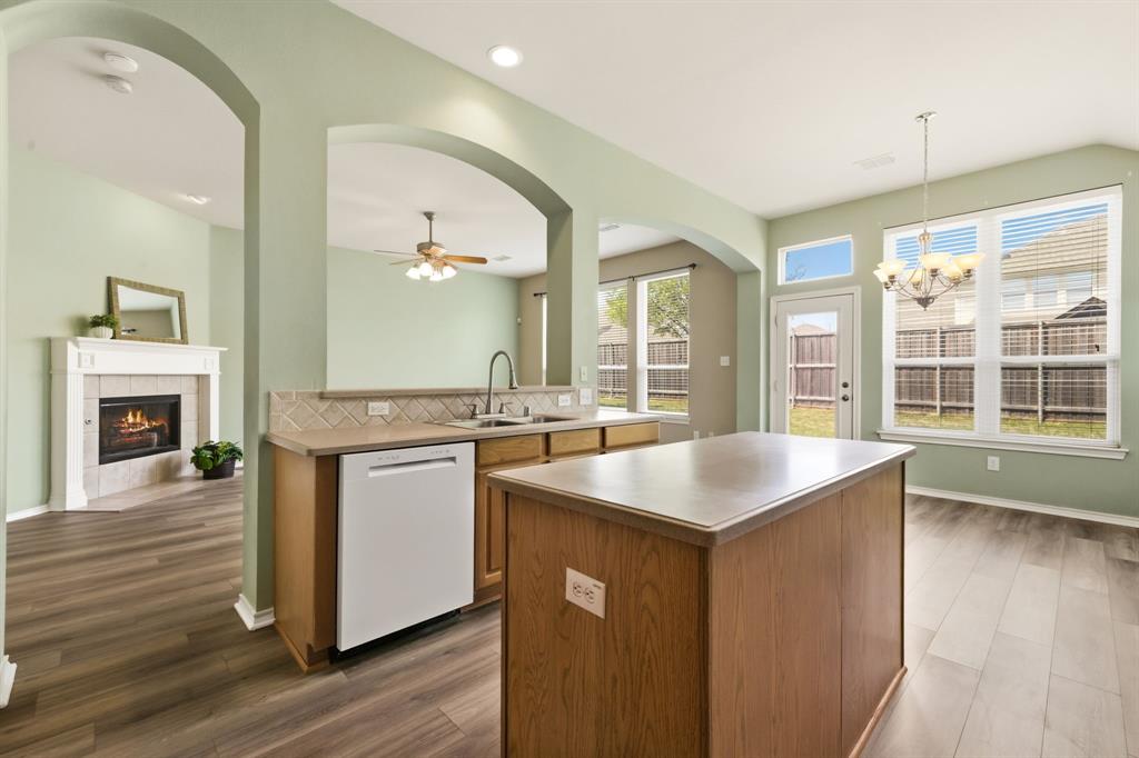 2210 High Point Drive Sachse, TX 75048 - Photo 14 of 23 a kitchen with a sink stove and wooden floor