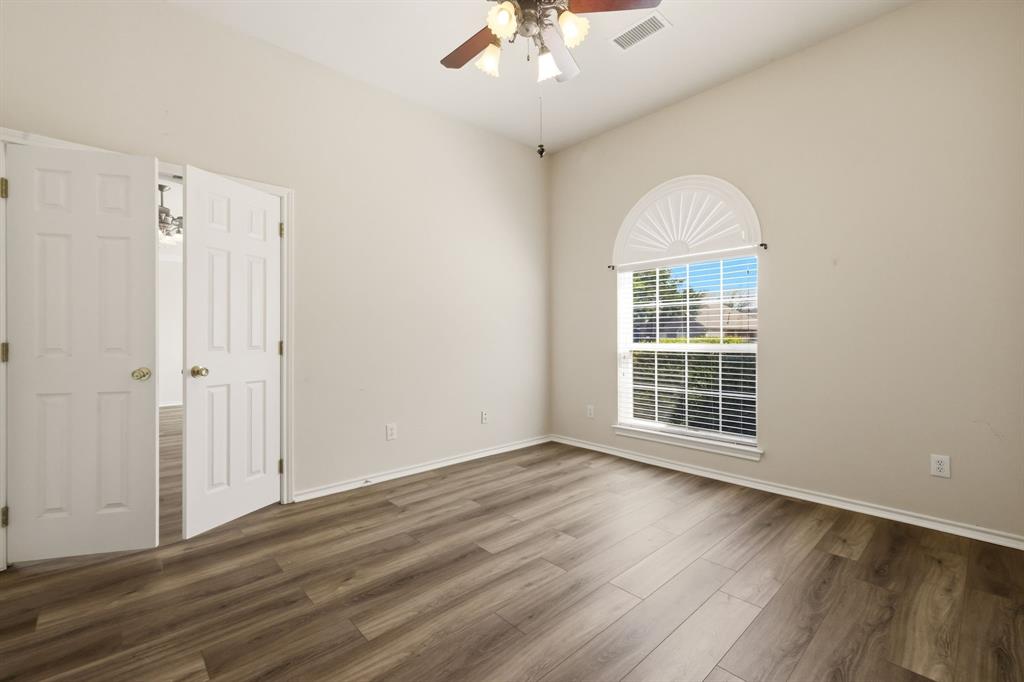 2210 High Point Drive Sachse, TX 75048 - Photo 15 of 23 a view of an empty room with wooden floor and a window