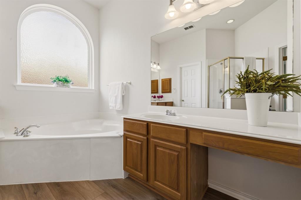 2210 High Point Drive Sachse, TX 75048 - Photo 19 of 23 a bathroom with a bathtub a double vanity sink and mirror