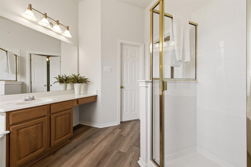 2210 High Point Drive Sachse, TX 75048 - Photo 20 of 23 a bathroom with a double vanity sink and mirror