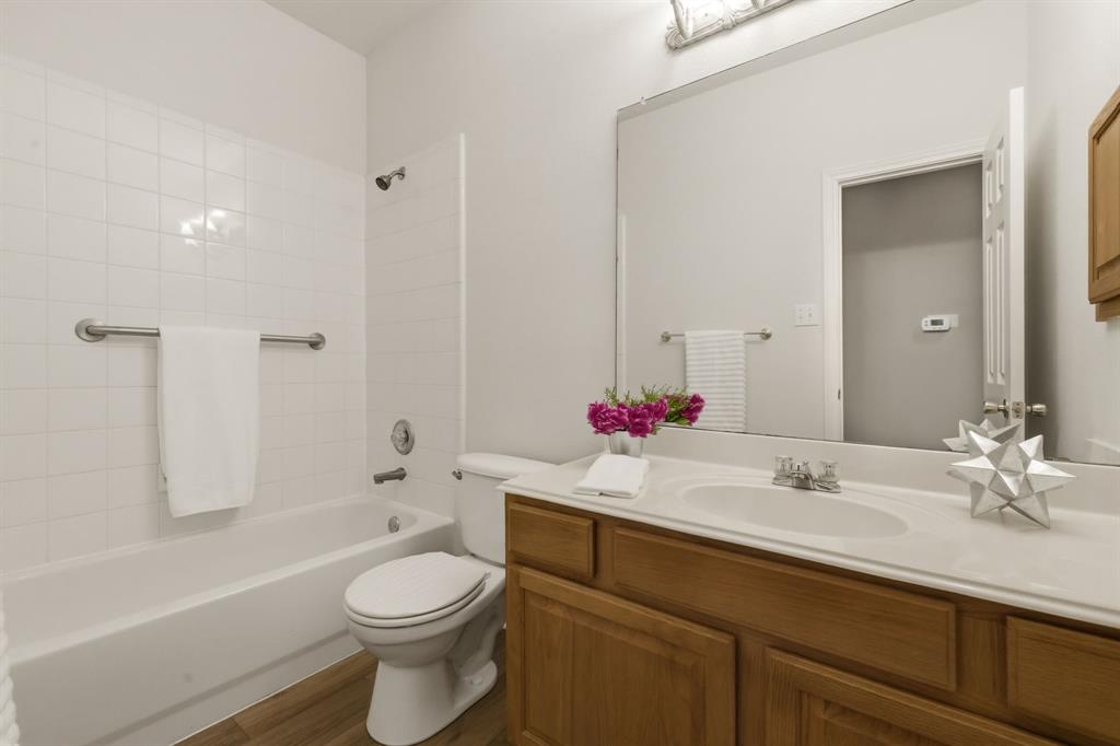2210 High Point Drive Sachse, TX 75048 - Photo 22 of 23 a bathroom with a sink a toilet and shower