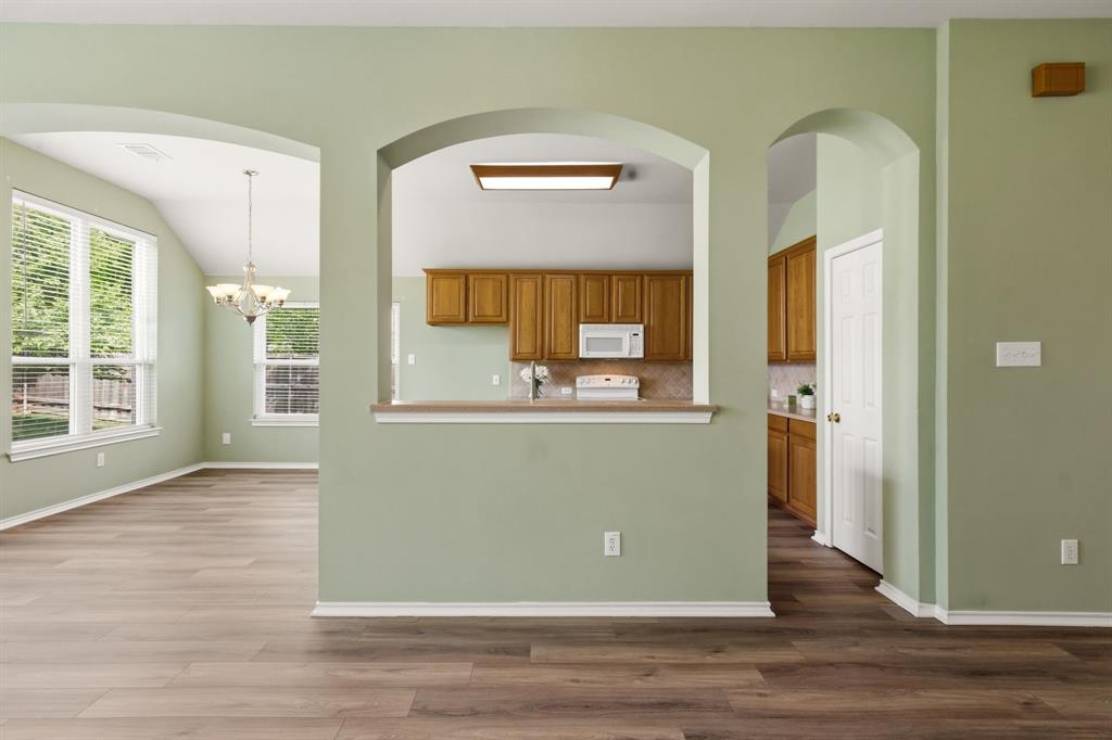 2210 High Point Drive Sachse, TX 75048 - Photo 23 of 23 an empty room with wooden floor and windows
