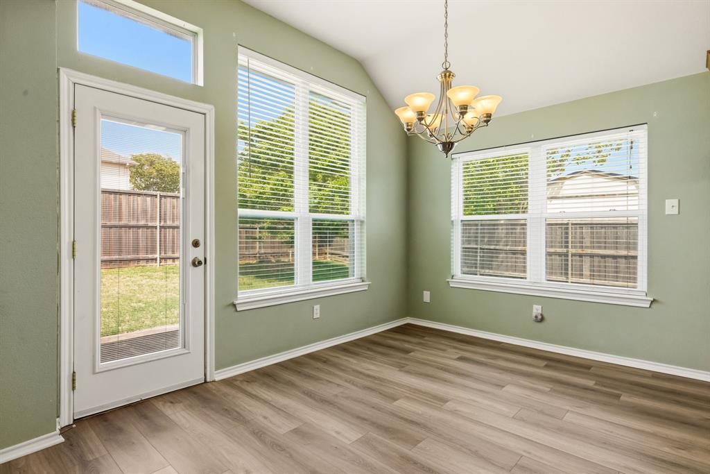 2210 High Point Drive Sachse, TX 75048 - Photo 9 of 23 a view of an empty room with a window and wooden floor