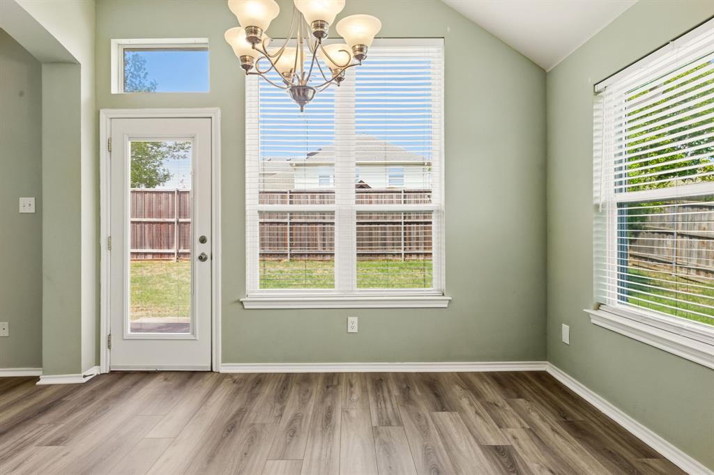 2210 High Point Drive Sachse, TX 75048 - Photo 10 of 23 an empty room with wooden floor and windows