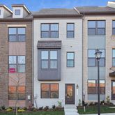 a front view of a residential apartment building with a yard