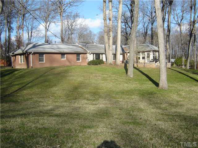 815 Goodwin Road Durham, NC 27712 - Photo 1 of 15 a view of a brick house with a yard