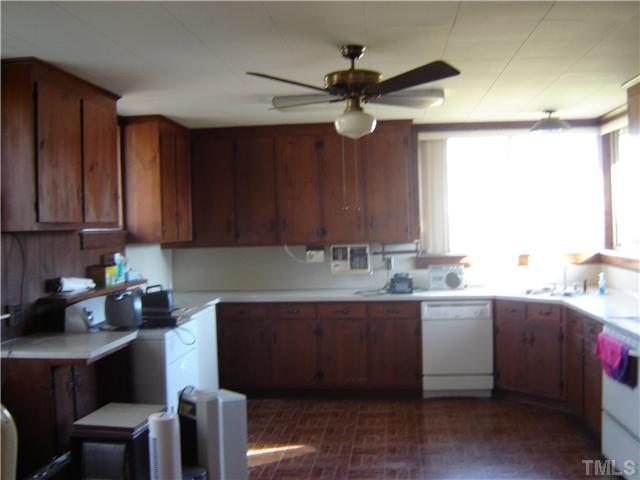 815 Goodwin Road Durham, NC 27712 - Photo 9 of 15 a kitchen with a sink cabinets and window