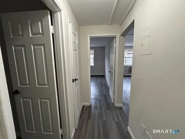 a view of a hallway with wooden floor