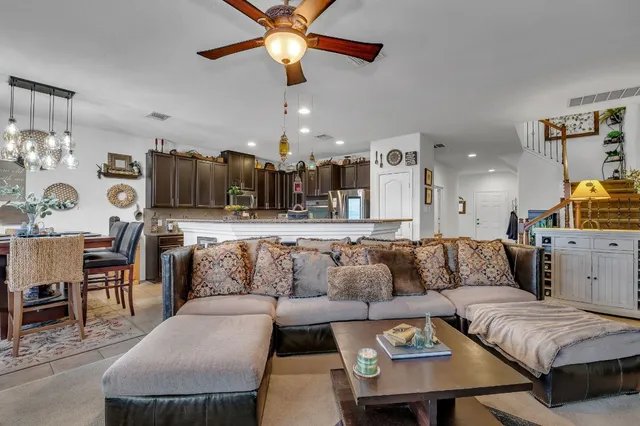a living room with furniture and kitchen view