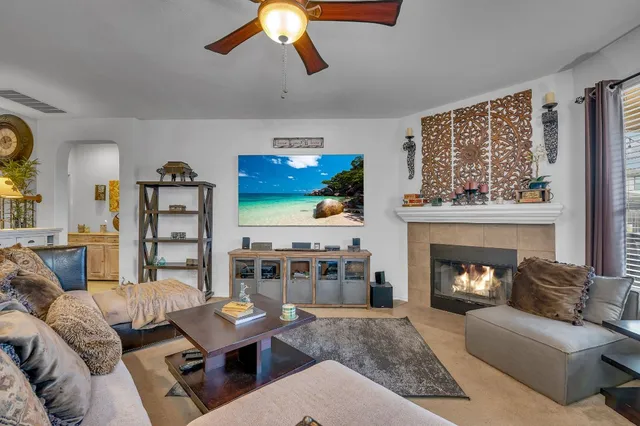 a living room with furniture and a fireplace