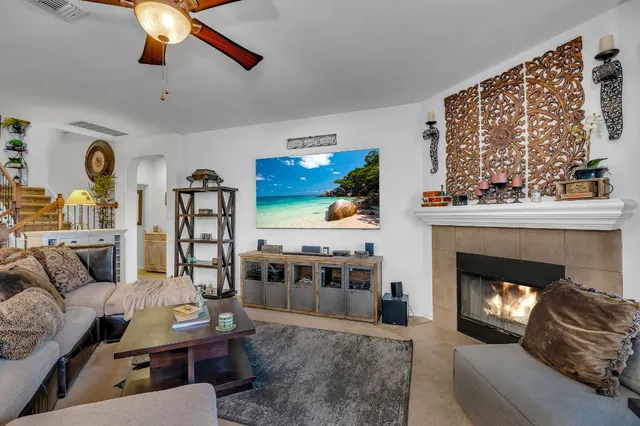 a living room with furniture and a fireplace