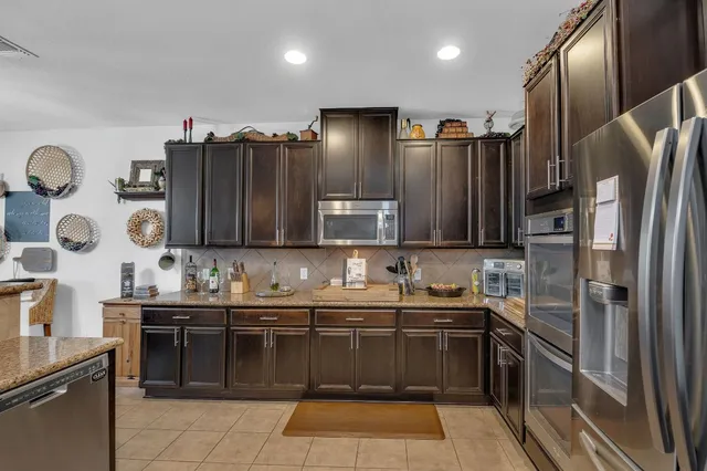 a kitchen with stainless steel appliances a sink stove and refrigerator