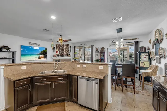 a kitchen with stainless steel appliances granite countertop a sink and a wooden cabinets