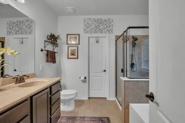 a spacious bathroom with a granite countertop sink a toilet and shower