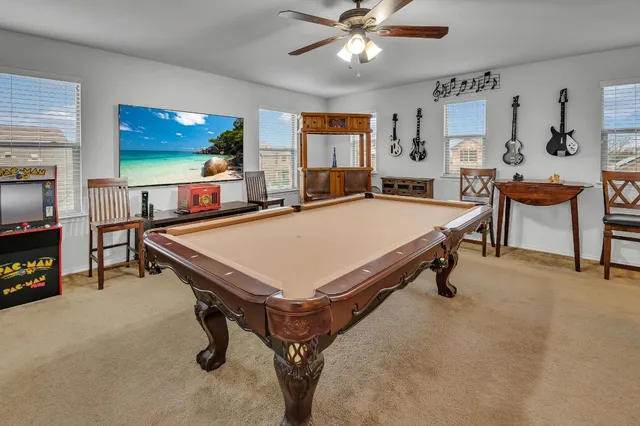 a room with pool table and flat screen tv