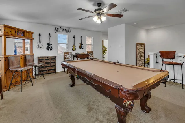 a room with pool table and furniture