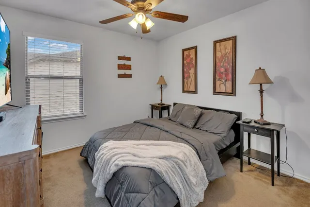 a bed sitting in a bedroom next to a window