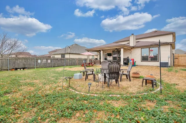 a view of a yard with table and chairs