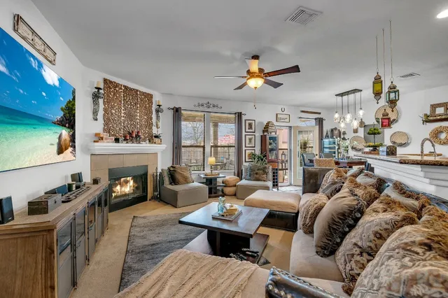 a living room with furniture fireplace and a large window