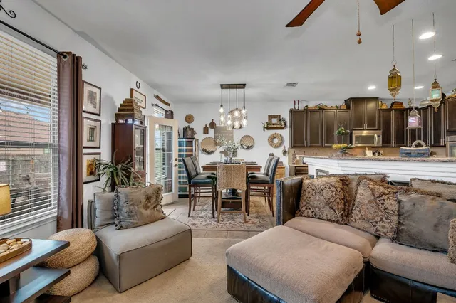 a living room with furniture and a chandelier