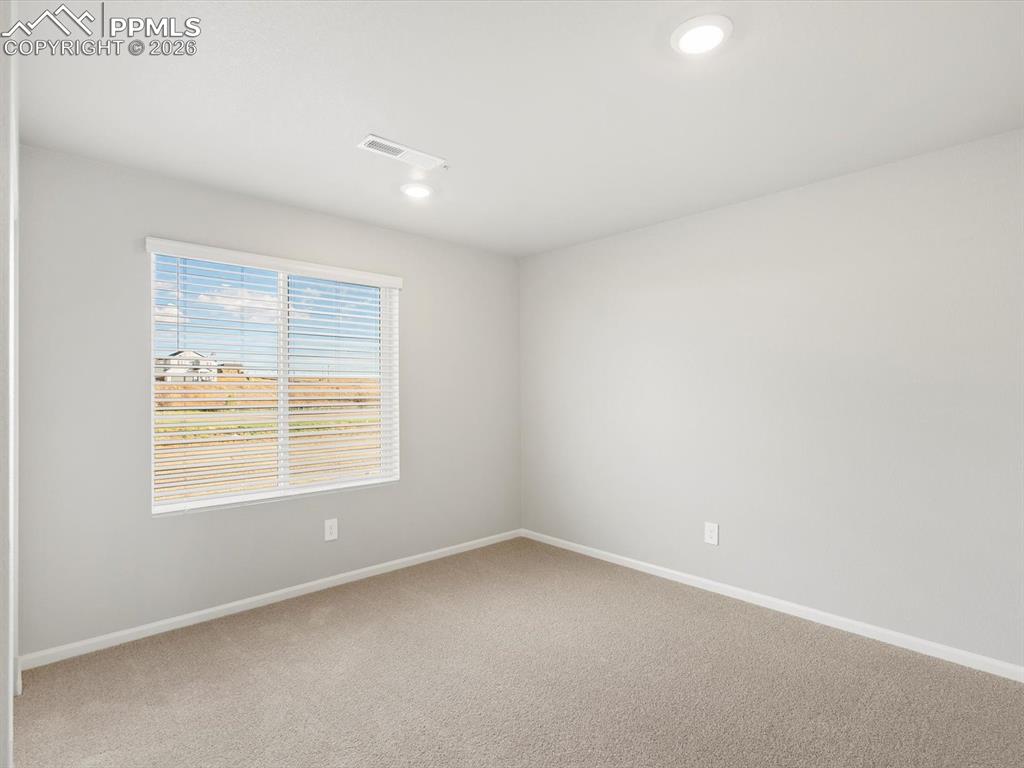 6754 Roundtail Way Colorado Springs, CO 80925 - Photo 12 of 31 an empty room with a window