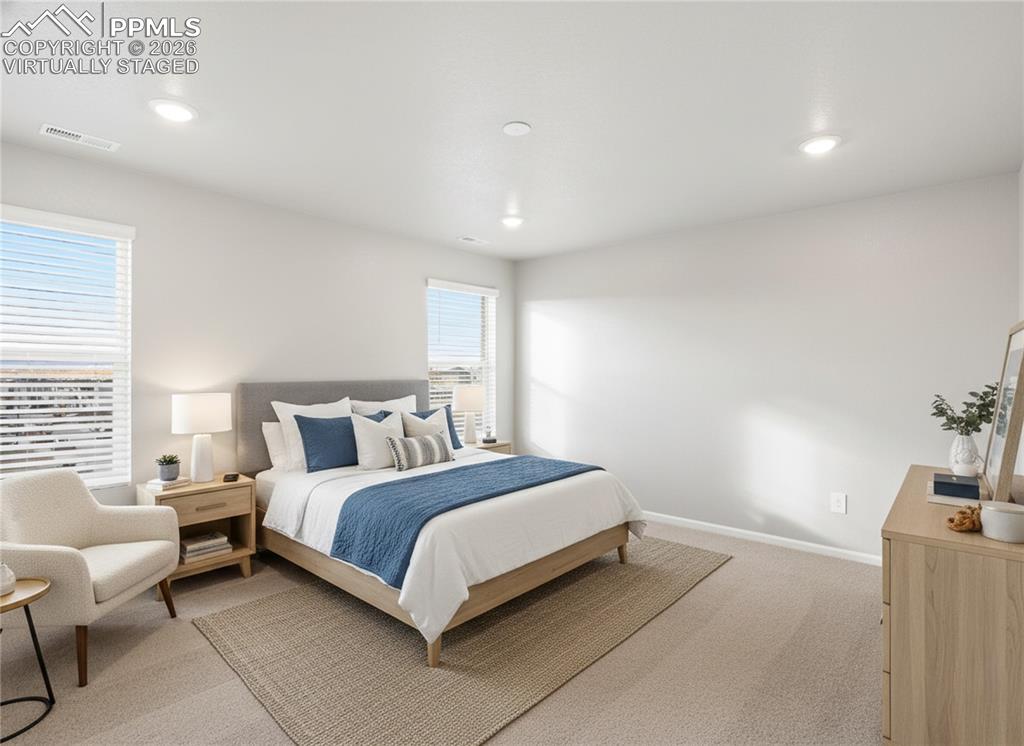 6754 Roundtail Way Colorado Springs, CO 80925 - Photo 13 of 31 a bedroom with a bed and window