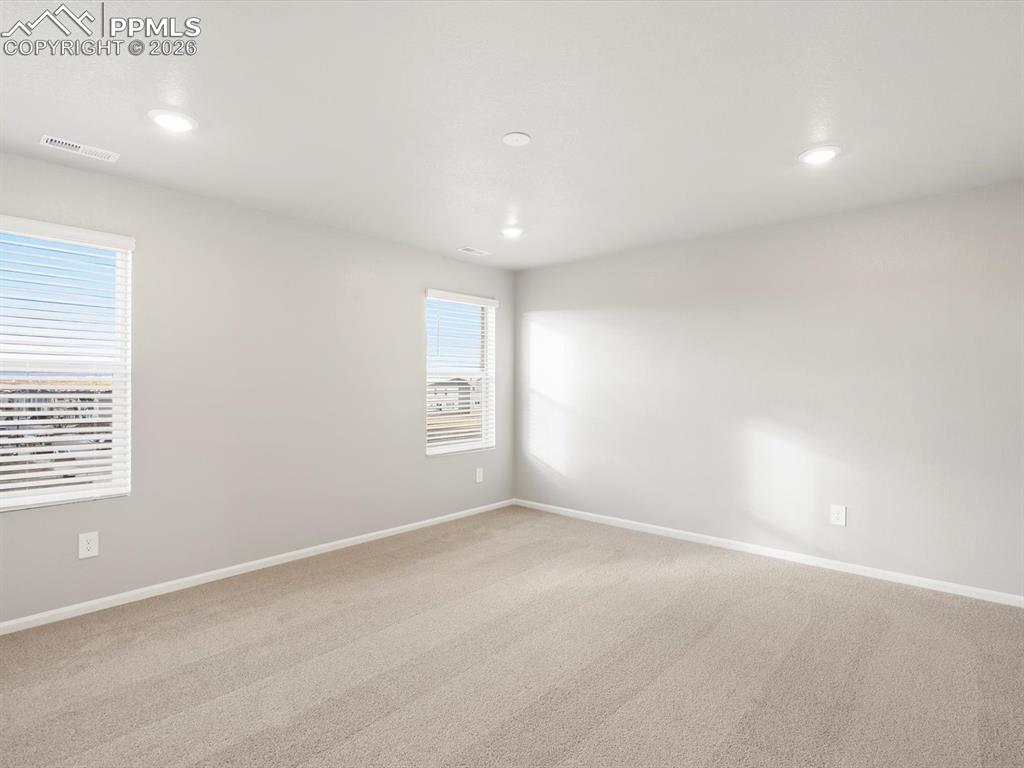6754 Roundtail Way Colorado Springs, CO 80925 - Photo 14 of 31 an empty room with windows