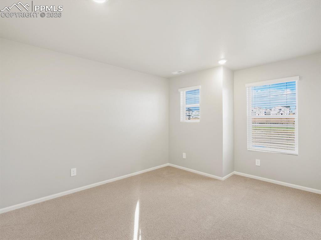 6754 Roundtail Way Colorado Springs, CO 80925 - Photo 16 of 31 an empty room with windows
