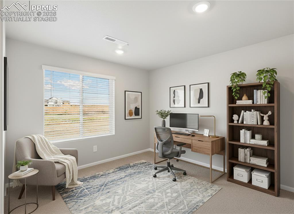 6754 Roundtail Way Colorado Springs, CO 80925 - Photo 17 of 31 a view of a workspace with a window and lounge chair